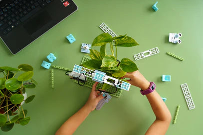 Overhead shot of student working on Smart Farming project from the Climate Action Kit