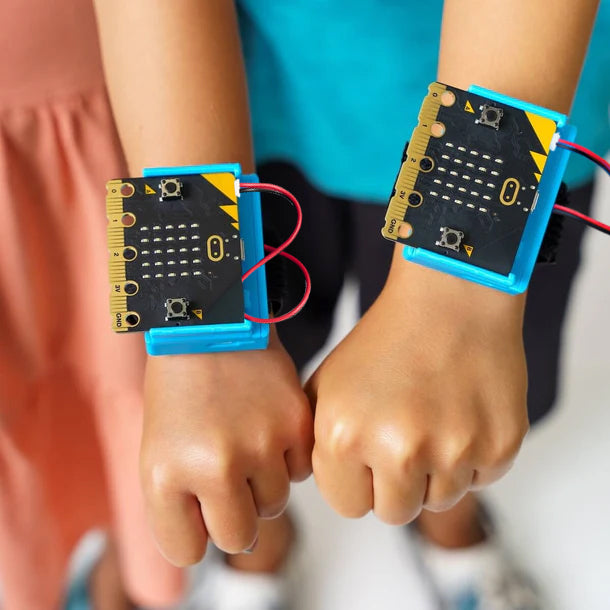 Two students wearing CHARGE for micro:bit on their wrists