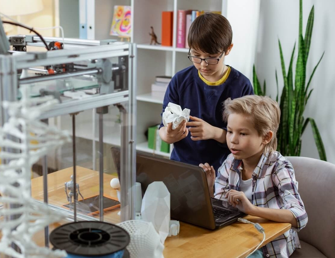 Two male students looking at a 3d printed object